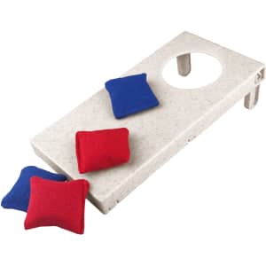 A wheat straw cornhole board in white with red and blue bean bags. The board features a circular hole for gameplay.