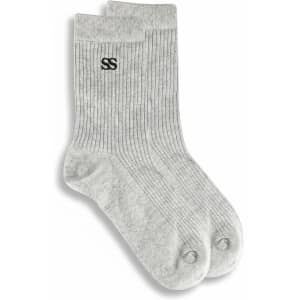 A pair of grey lounge socks featuring a ribbed texture and a logo on one side.