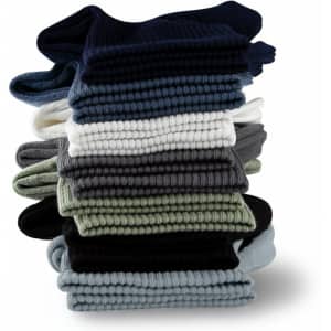 A stack of Breathe Fit Socks in various colours, including navy, green, grey, white, and black. The socks have a ribbed texture.