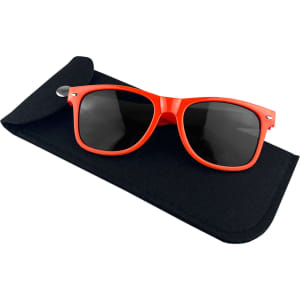 A pair of black sunglasses with vibrant red frames resting on a black felt pouch featuring a closure.