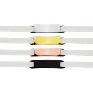 Four shoelace charms in silver, gold, rose gold, and black, attached to white shoelaces, with a logo present.