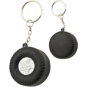 A black tyre-shaped key ring with a silver centre, featuring a metal chain and keyring attachment.