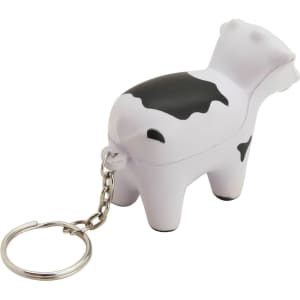 A white and black stress cow key ring with a keychain attachment. The design features a playful cow shape.