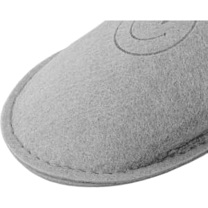 A grey felt slipper featuring a stitched edge and a small logo.