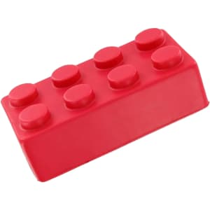 A red stress building block shaped like a toy brick, featuring rounded knobs on top. It has a logo on one side.
