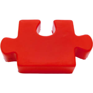 A red jigsaw puzzle piece made of stress-relieving material, featuring smooth edges and a glossy finish.