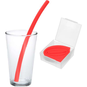 A red silicone straw in a clear glass next to a transparent case holding another red straw.