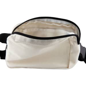 A cream cotton belt bag with a zippered closure and black trim, featuring an open interior.
