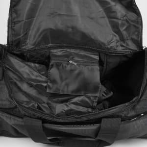 A black duffle bag interior with a zipped pocket and spacious main compartment. It features a logo.