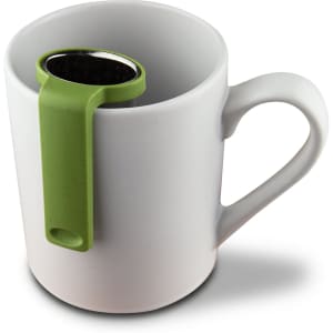 A white mug with a green tea infuser resting on the rim, featuring a sleek design and stainless steel mesh.