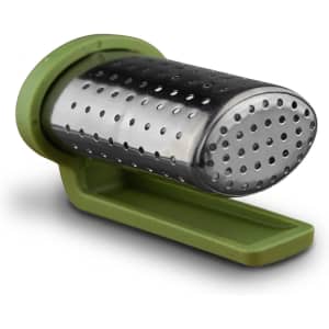 A travel tea infuser in silver metal with a green plastic base, designed for steeping loose tea.