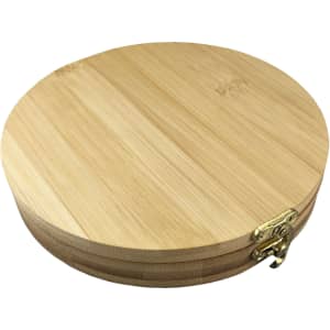 A round bamboo toolkit featuring a brass clasp, showcasing a natural wood finish.