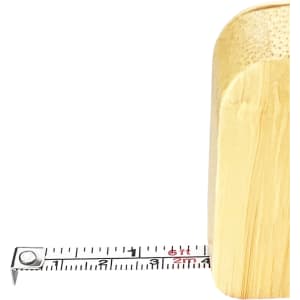 A bamboo tape measure key ring in natural brown, with a visible retractable tape marked in centimetres.