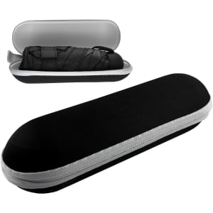 A black umbrella encased in a sleek, oval hard shell case with a silver zipper detail. The case is partially open.