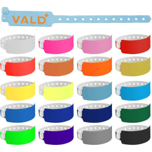 A collection of 25mm vinyl wristbands in various colours, featuring a logo on one band.