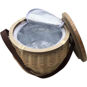 A round wicker picnic cooler basket with a wooden lid and insulated interior, featuring a brown strap.