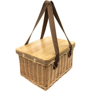 A square wicker picnic cooler basket in natural hues with a wooden lid and brown straps. Features a logo.
