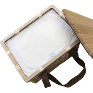 A square wicker picnic cooler basket with a light-coloured interior and brown straps, partially open.