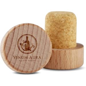 A wooden wine stopper with a cork top, featuring a circular base and a logo design.