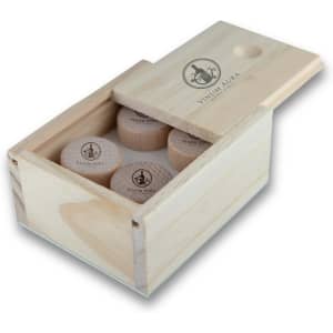 A wooden box containing several classical wood wine stoppers, featuring a logo on the lid.