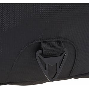 A close-up of a black fabric section of a laptop backpack featuring a logo and a buckle attachment.