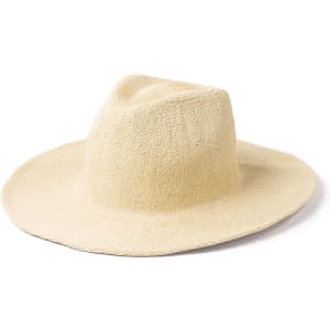 A straw hat in a light beige colour with a wide brim and a soft crown. It features a logo on the band.