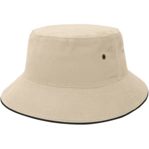 A beige bucket hat featuring a wide brim and eyelets, with a contrasting trim around the base.