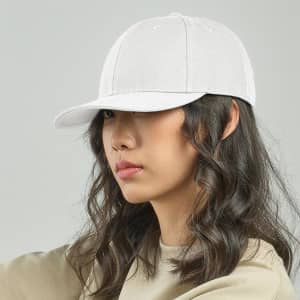 A white cap with a curved brim, featuring an adjustable strap and a logo. The model has wavy hair.