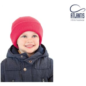 A red beanie for children worn by a smiling child in a navy blue jacket. The beanie features a logo.