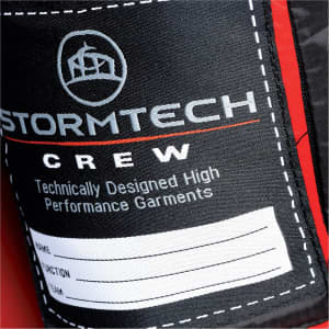 A close-up of a label on a red puffer jacket, featuring a logo and space for personal details.