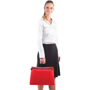 A woman holding a red satchel bag with a zip closure. The satchel features a logo.