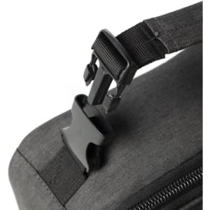 A grey cooler bag with a prominent black buckle strap attachment. It features a simple, minimalist design.