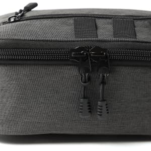A cooler in dark grey fabric with a zippered closure and black pull tabs, featuring a logo.
