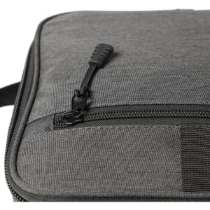 A grey cooler bag featuring a zippered closure and textured fabric. It includes a logo.