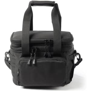 A black expanding cooler with dual zippers, sturdy handles, and an adjustable shoulder strap, featuring a front pocket and logo.