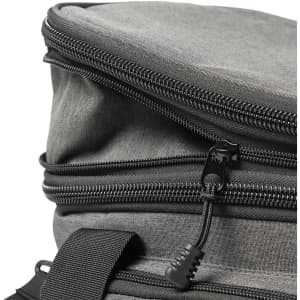 A grey cooler bag with a double zipper and black zip pulls, featuring a sturdy handle for carrying.