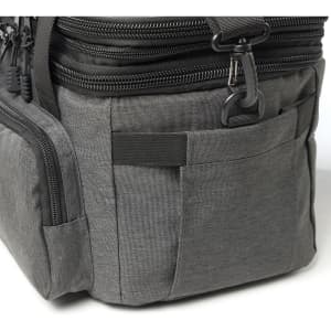 A grey cooler bag with multiple zippered compartments and pockets, featuring a logo on the side.
