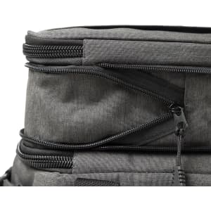 A grey expanding cooler with zippers and compartments for storage. Features a sleek, modern design.