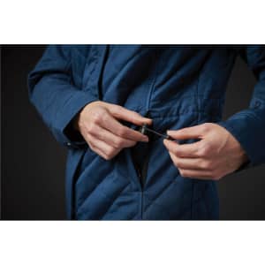 A women's quilted puffer jacket in blue, featuring a zip pocket and adjustable drawstring.