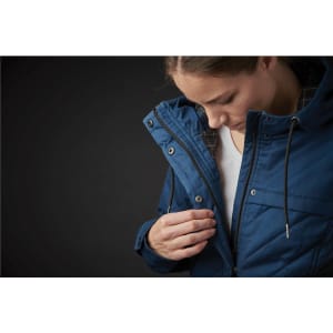 A women's puffer jacket in blue, featuring a quilted design and a zippered front, with a hood and logo.