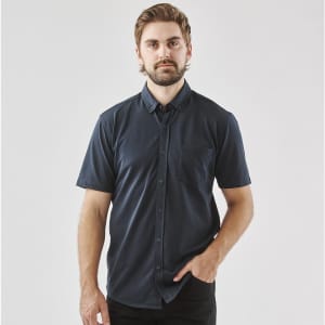 A navy blue men's short sleeve knit shirt with a button-up front and a single chest pocket.