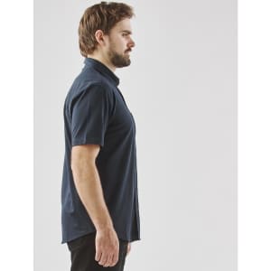 A side view of a navy blue men's short sleeve button-up shirt, featuring a collar and a logo.