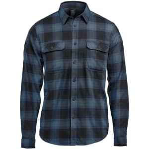 A button-up shirt in blue and black plaid with two chest pockets and a collar. Features a logo.