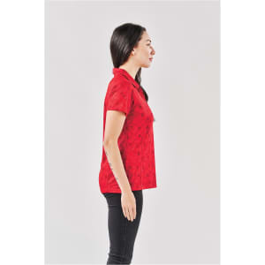 A red Women's Galapagos Polo shirt displayed on a model, viewed from the side. The shirt features a collar and has a logo.