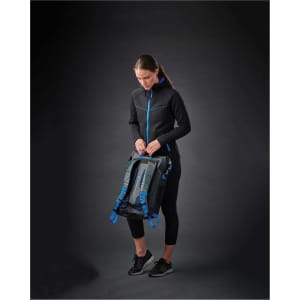 A woman wearing a black women's Logan Performance Hoody with blue accents, holding a bag against a dark background.