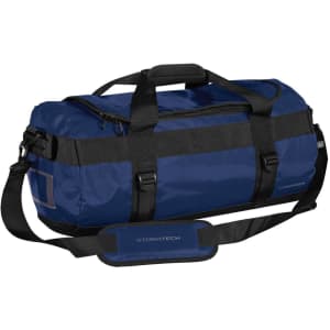 A small blue duffle bag with black straps and branding, featuring a zippered top and side grab handle.