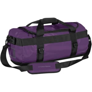 A small duffle bag in purple with black straps, featuring a handle, adjustable shoulder strap, and a logo.