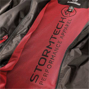 A black jacket with a red lining and mesh interior, featuring a logo and text.
