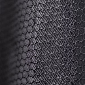 A close-up of a textured black fabric featuring a hexagonal pattern. The fabric appears durable and supportive.