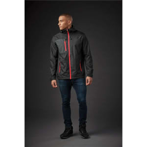 A man wearing a black rain jacket with grey and orange accents, featuring a hood and front pockets.